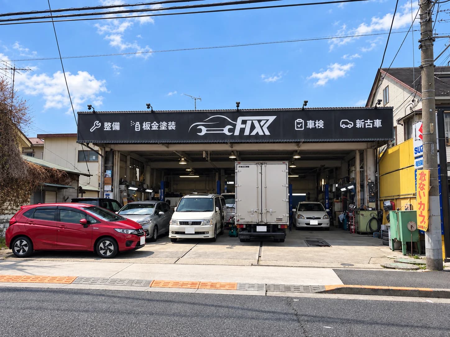Front view of the Fixx Akishima garage with its black signboard